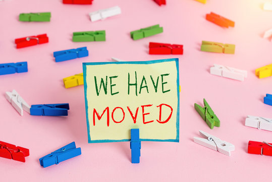 Text sign showing We Have Moved. Business photo text To go from one residence or location to another Relocate Colored clothespin papers empty reminder pink floor background office pin