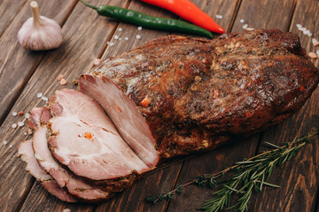 Traditional smoked meat on wooden table. Culinary meat eating.
