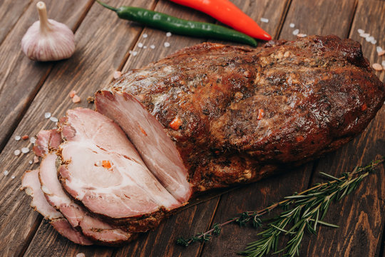 Traditional smoked meat on wooden table. Culinary meat eating.