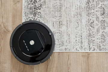 Robotic vacuum cleaner on the floor in cozy modern living room