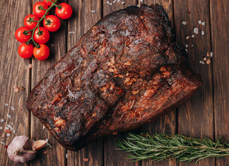 Traditional smoked meat on wooden table. Culinary meat eating.
