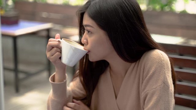 young asian woman drink in coffee shop. beautiful girl with coffee