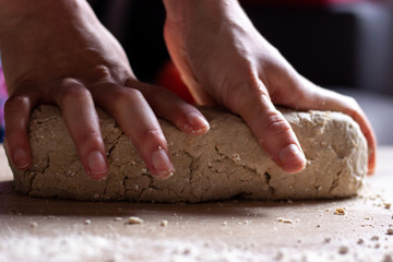 Working hands kneading bread gluten free dough