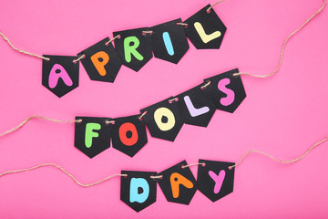 Text April Fool's Day on pink background