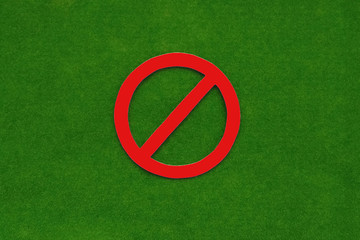 Forbidding sign in red on a green background. No, you can't.