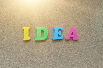 The word idea consists of colored letters on a cork Board background. Business idea, creative.