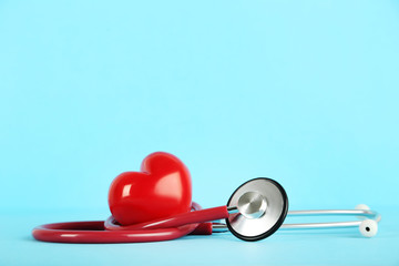 Stethoscope with red heart on blue background