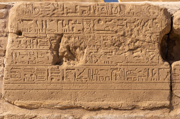 Karnak Temple, complex of Amun-Re. Embossed hieroglyphics on walls. Luxor Governorate, Egypt.