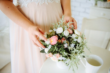 wedding bouquet in brides hands of bride