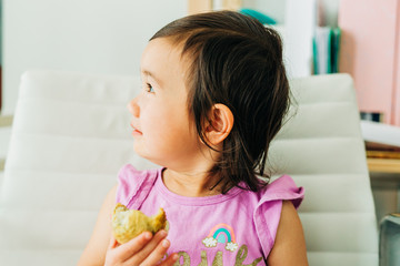 Toddler Girl Eating Banana Muffin