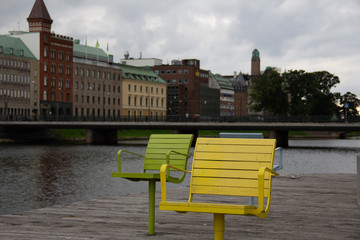 The outdoor seats by the canal is empty in downtown Malmö, Sweden, as people stays home during this overcast day