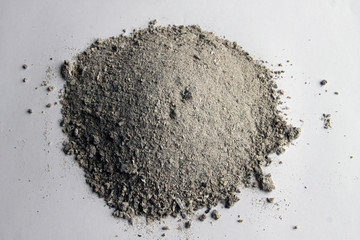 poured into a puddle gray ashes remaining on a white background