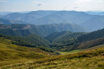 Fototapeta premium Aerial view above in the mountains and meadows. Beautiful landscape on a summer day. Carpathian of Ukraine. Holidays in the mountains.