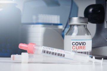 Coronavirus COVID-19 vaccine glass bottle in the laboratory. Cure for coronavirus un a test tube. Blood test tube for 2019 nCoV analysis. Chinese corona virus blood test concept.