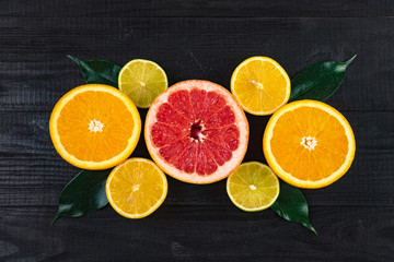 Fototapeta na wymiar cut oranges, grapefruits, limes and lemons. view from above.. citrus vitamins