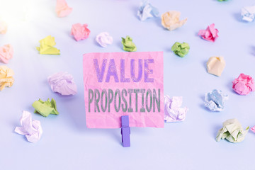 Conceptual hand writing showing Value Proposition. Concept meaning feature intended to make a company or product attractive Colored crumpled papers empty reminder blue floor clothespin