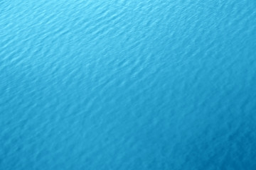 blue water background texture of sea surface top down view Natural color of ocean aqua with waves Backdrop for design