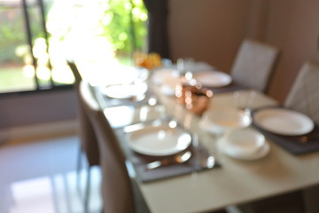 dish ware sets arrange on dining table inside eating room of home, image blur background