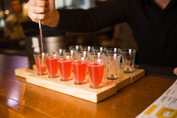 bartender pours the cocktails