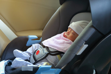 cute newborn baby sleeping in car seat safety belt lock protection drive road trip