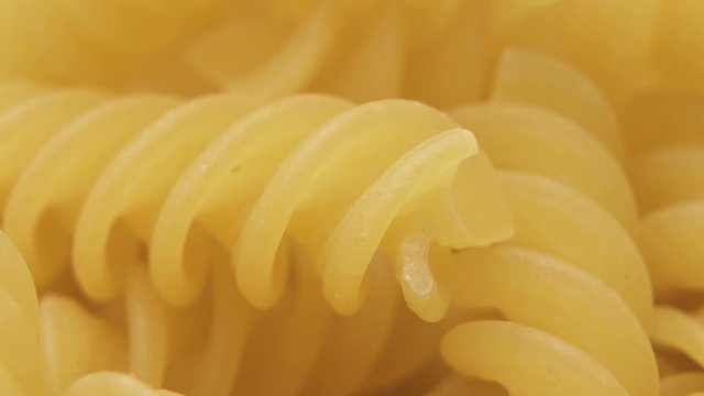Raw uncooked dry italian fusilli pasta. Corkscrew spiral shape