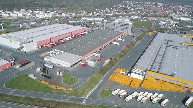 Rosbach, Germany - March 27, 2020: Aerial view of large distribution center of REWE and PENNY. The REWE Group is a German diversified retail and tourism co-operative group.