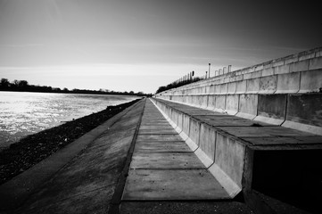 Fototapeta premium Landscape Quay on the river bank in the European city concrete stairs to relax people black and white photo