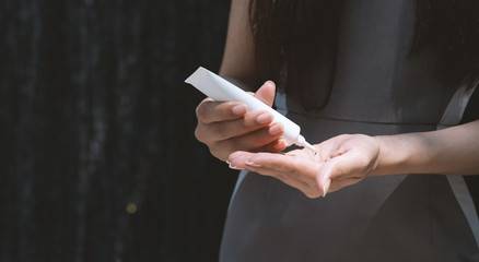 Young woman using alcohol gel sanitizer wash her hand for prevent infection coronavirus.  Antibacteria concept. Hand sanitizer gel.