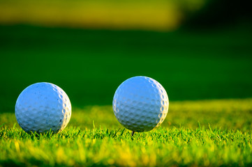 Excellent well-kept green grass lawn on large golf course, green section with big white foam balls for beginners on Tenerife island, Canary, Spain