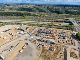 Aerial view of investors and contractors on construction site with crane. New construction site...