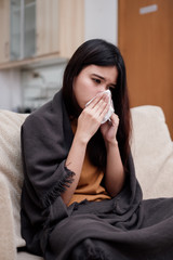 Portrait of a sneezing and sick flu young woman asian at home. Pandemic 2019 Coronavirus 2019-nCoV Concept.