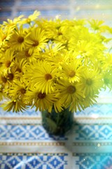 Yellow wildflowers in a vase on the table
