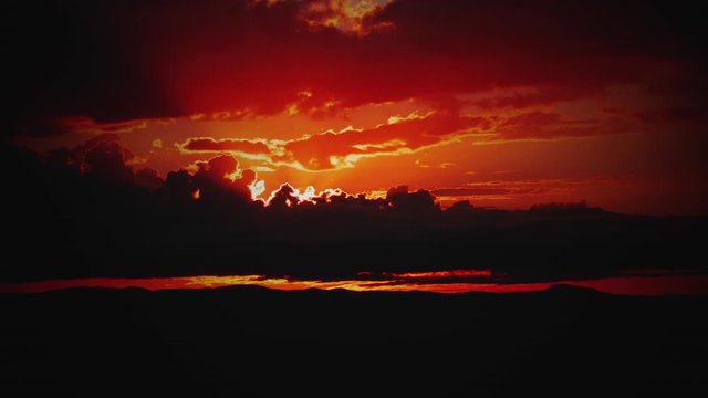 Fire Red Sunrise behind Storm Clouds Wide Time-lapse