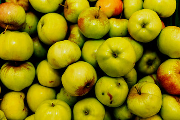 Juicy green apples on a store counter. Vegetarianism and raw food diet. Close-up. View from above.