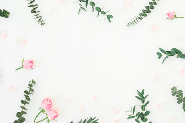 Fototapeta na wymiar Floral pattern with pink roses and eucalyptus on white background. Flat lay, top view.
