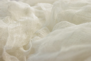 white color woven cotton gauze fabric background texture. close up top view.