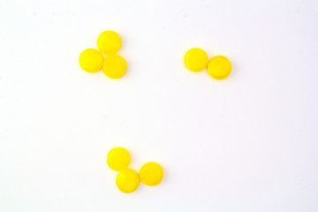 yellow pills on white background