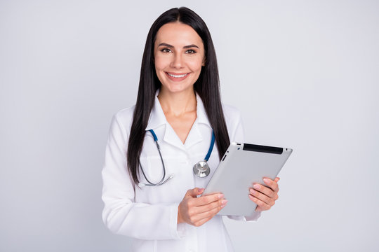 Photo of beautiful cheerful professional doc lady writing patient digital contract insurance in modern e-book wear stethoscope white lab coat isolated grey color background