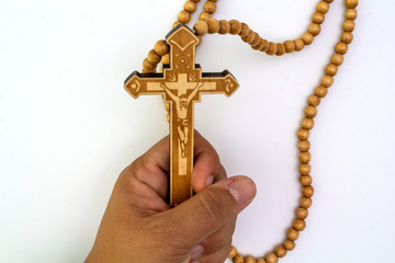 Crucifix necklace  The top has a light brown Jesus on a white background.