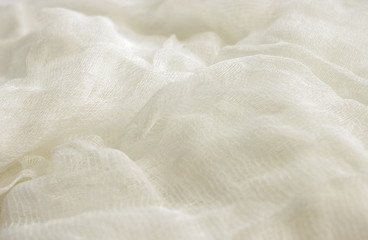 Obraz premium white color woven cotton gauze fabric background texture. close up top view. Selective soft focus. Shallow depth of field. Text copy space.