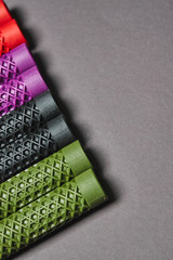 Bmx handlebar grips of different colors lie on the table. Spare parts for a bicycle wheel.