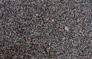 Background of red-black granite. The texture of red-black granite.