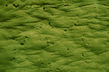 Texture of green pleated green surface with folds