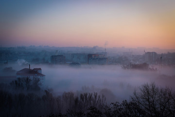 Naklejka na ściany i meble Winter Sunrise Over The City Covered With Fog