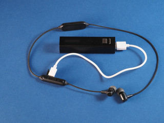 Wireless headphones are charging from power bank