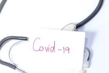 word Covidt-19, on a white background. Medical stethoscope