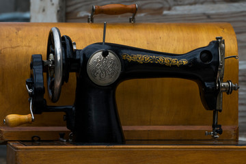 Vintage sewing machine. Retro. History of sewing. Cover, elements and details of a sewing machine close-up. Macro photo.
