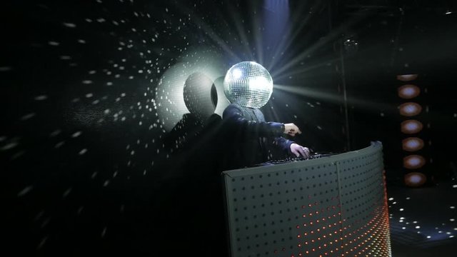 dj dancing with disco ball on his head
