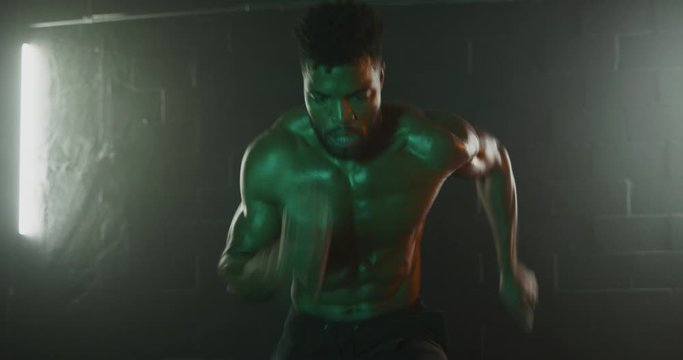 Man doing agility workout in dark gym