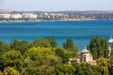 beautiful summer landscape with sea views and an ancient Byzantine temple among the green foliage of trees